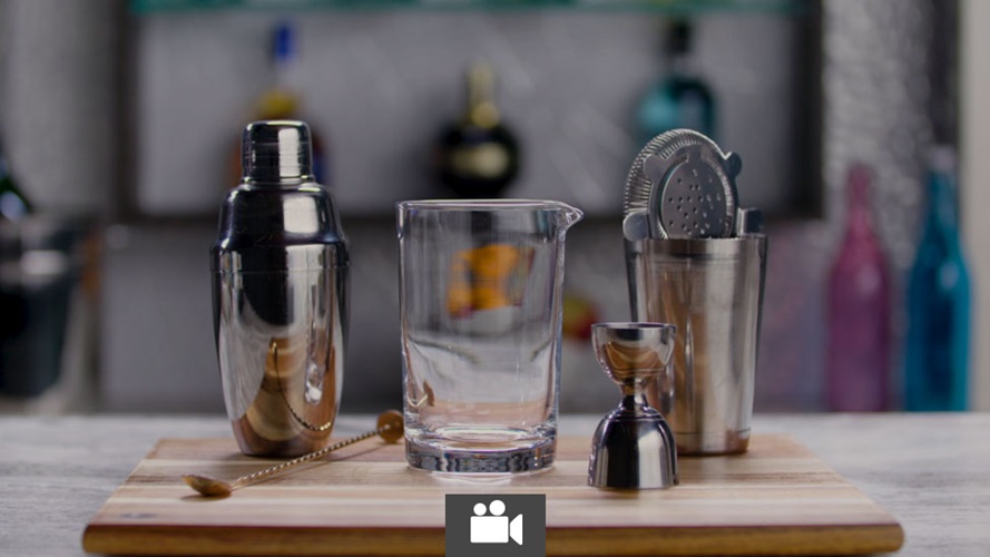 Cocktail mixing apparatuses on a cutting board, includes a shaker, a jigger, a pouring glass, a strainger and a bar spoon.