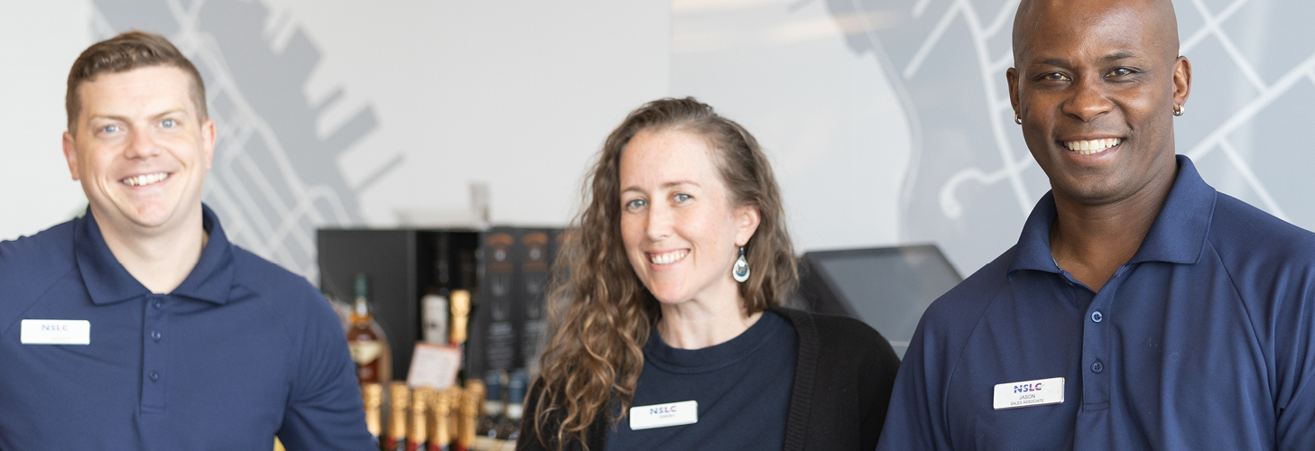 Three NSLC team members standing together smiling