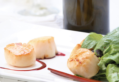 Cold poached scallops with field greens and ginger vinaigrette