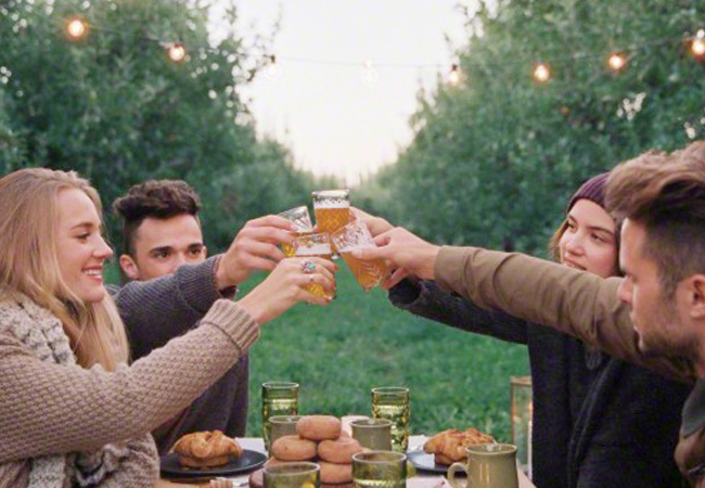 Raising glasses of cider with friends