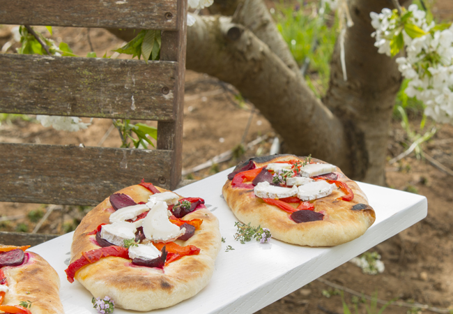 Cheese served on bread with tree in background