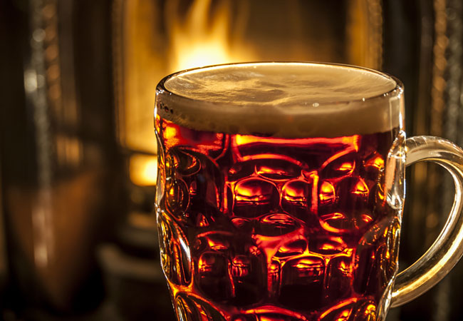 Pint of Nova Scotia beer by a fire
