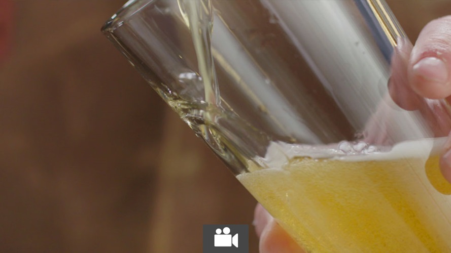 Beer being poured properly into a glass.