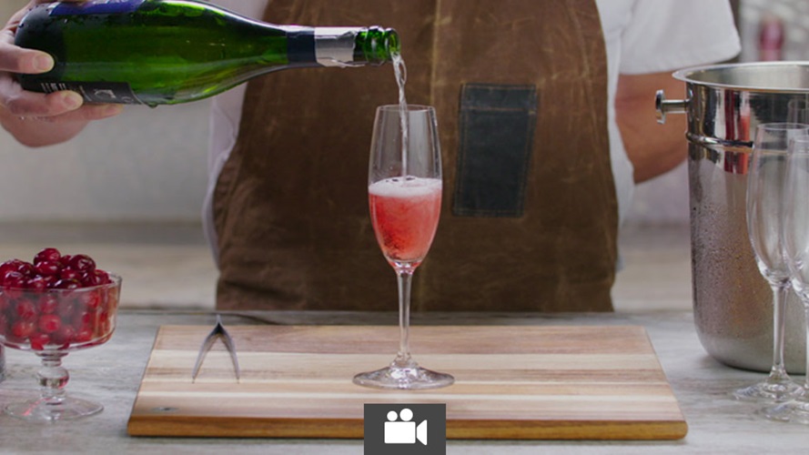 Bartender pouring sparkling wine into champagne flute