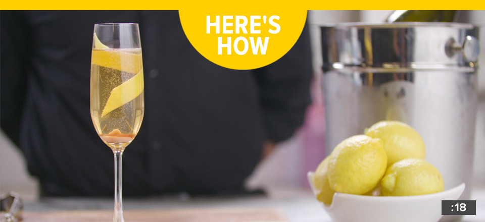 A champagne glass garnished with a lemon twist.