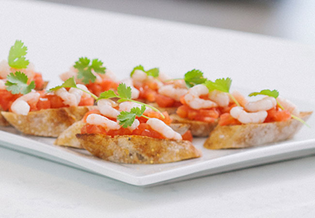 Shrimp bruschetta presented on a white plate