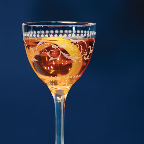 Close up of a Scotch drink in a ornate glass 