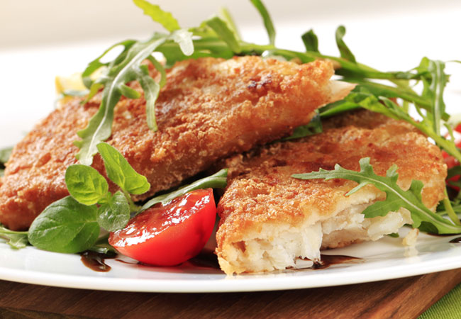 Pan Fried Haddock served with halved cherry tomatoes and arugula