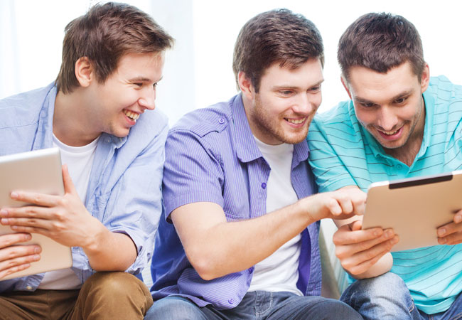 three friends enjoying tablet games