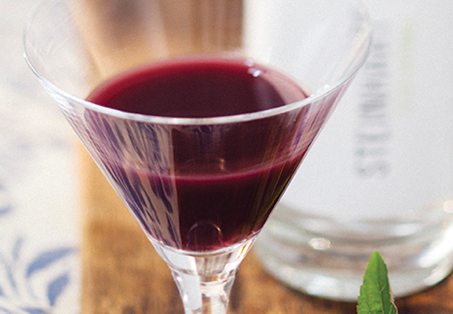 Berry-purple coloured cocktail in a martini glass