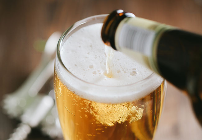 Close up of a glass of beer being poured