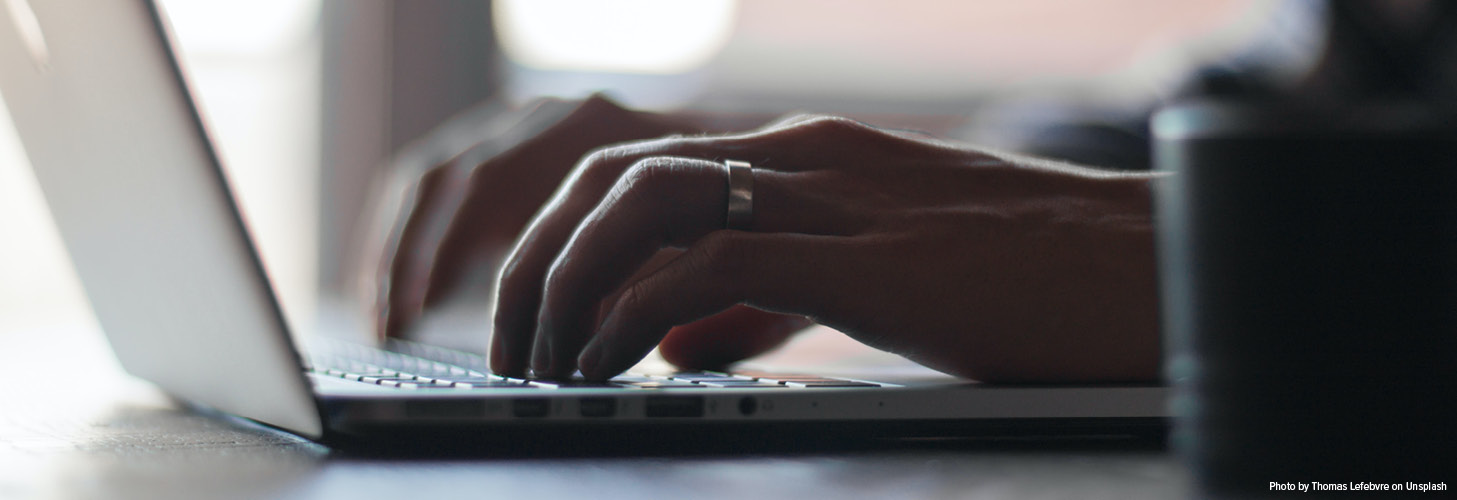 Someone with typing on a computer