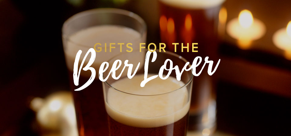 Two well-poured glasses of beer in front of some tea candles with text that says “Gifts for the Beer Lover”.
