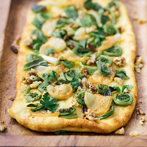 Flatbread pizza topped with fiddleheads