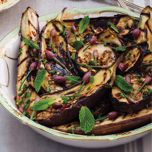 A bowl of grilled eggplant drizzled with honey 