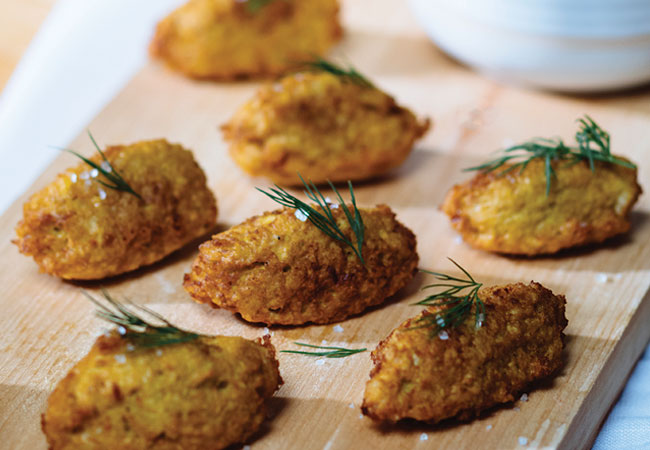 Cauliflower fritters on a wooden board