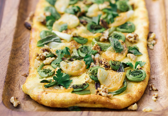 Flatbread pizza topped with fiddleheads