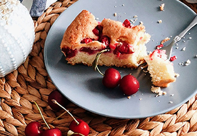 A piece of cherry pie on a plate