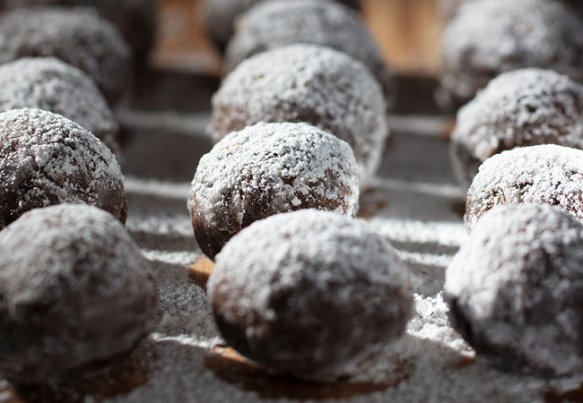 A tray of truffles sprinkled with icing sugar