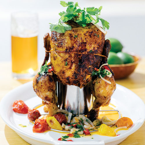 A whole chicken sitting on a beer can