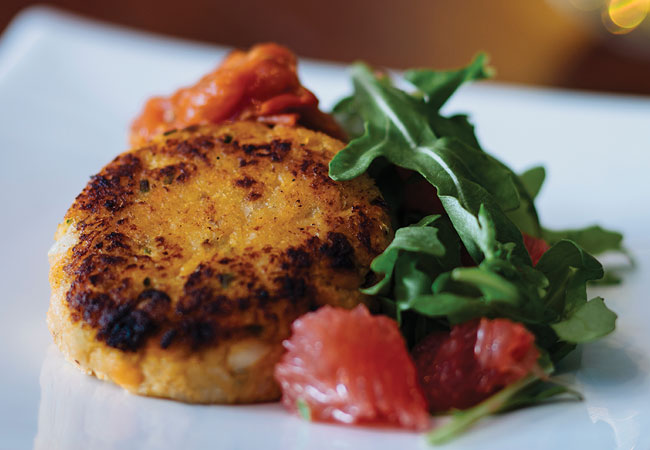 2 fish cakes topped with grapefruit and tomato chutney
