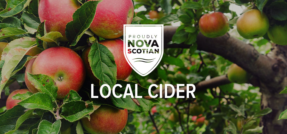 An apple tree full of bright red apples overlaid with a 'Proudly Nova Scotian