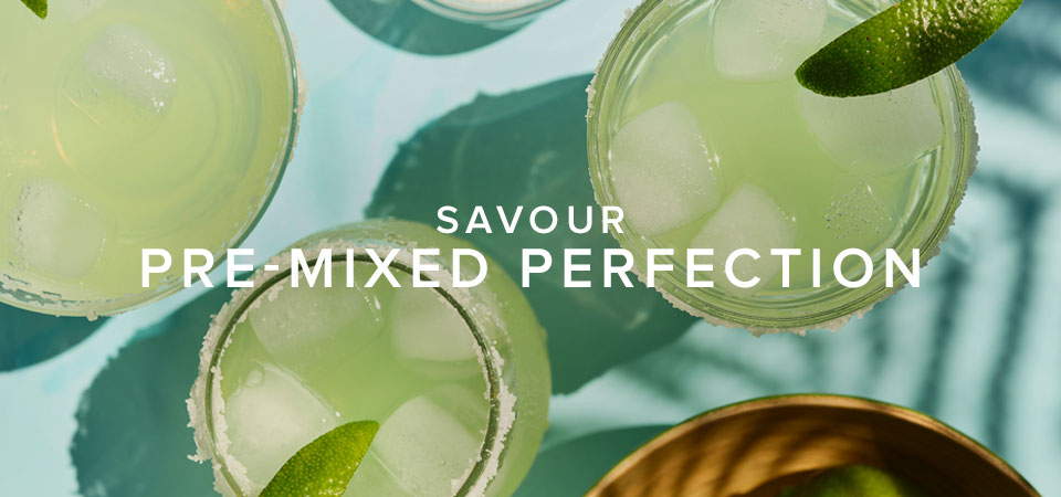 Three sugar-rimmed glasses filled with a pale green liquid and topped with lime. Includes text that reads, 'Savour Pre-Mixed Perfection'.