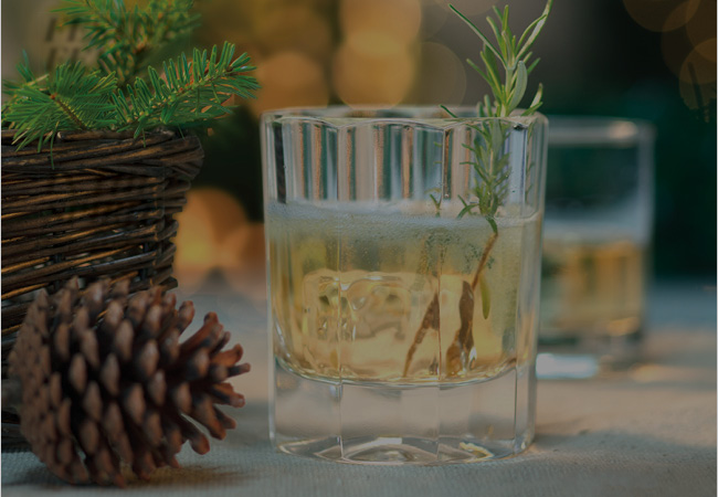 Whiskey tumbler with Heart of Gold Spritz with a sprig of rosemary for garnish