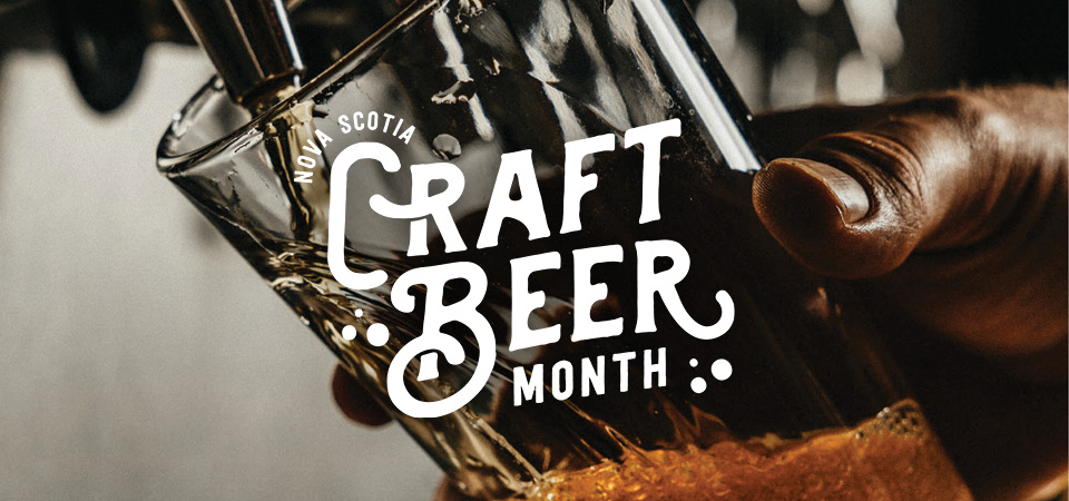 Nova Scotia Craft Beer Month. Glass of beer being poured from a tap in the backgroud