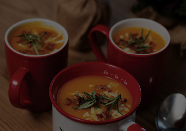 Three Cups of Baking Spice & Bacon Squash Soup with bacon and rosemary on the top as a garnish.