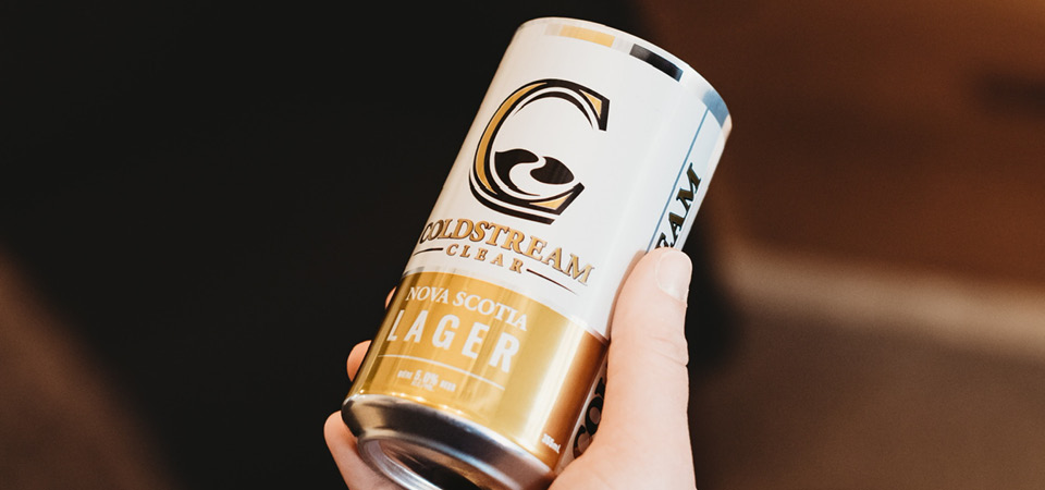 Person holding a can of Coldstream Lager