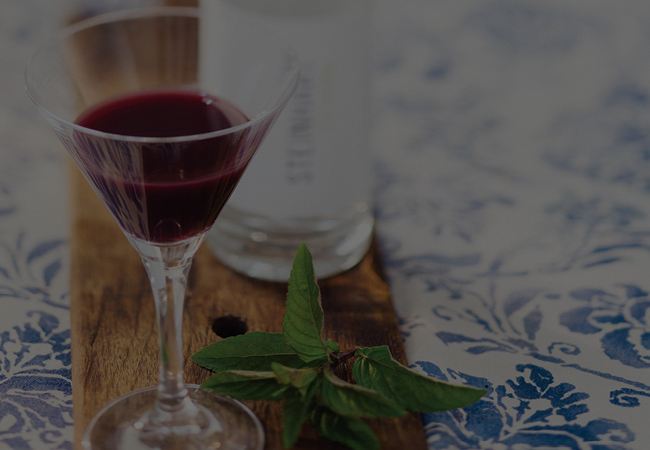 Haskap martini with mint garnish.