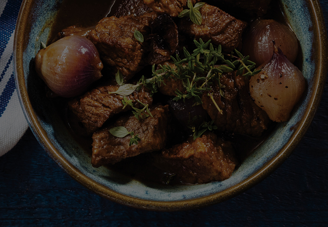 Guinness Braised Beef in a blue bowl.