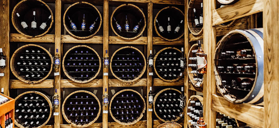 Wine bottles stored in wooden wine cellar