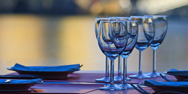 Set table with several empty wineglasses. 