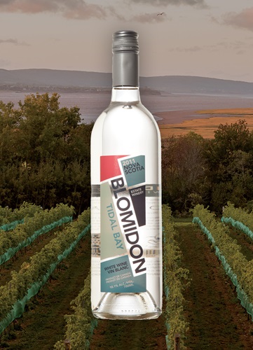 Vinyard overlooking ocean and mountain at dusk with a bottle of Image wine bottle centered.  