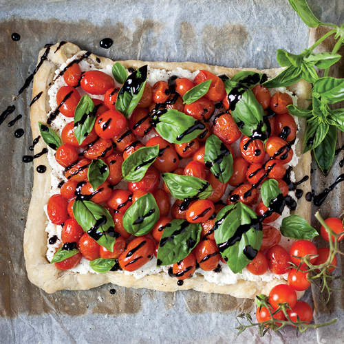 Ricotta tart smothered in cherry tomatoes, basil and a balsamic reduction
