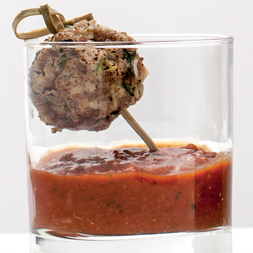 Skewered meat ball in a glass with marinara