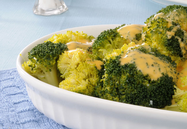 Bed of broccoli smothered in a creamy cheese sauce