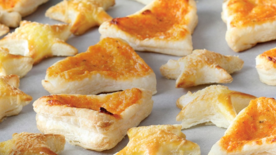 Assorted shapes of baked puff pastry on a cookie sheet