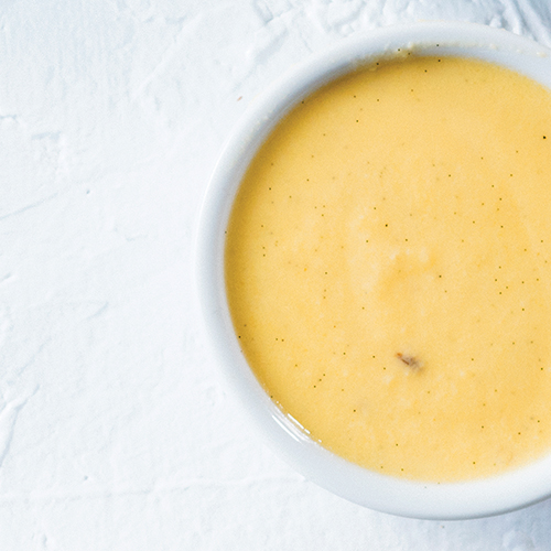 Small bowl containing a yellow creamy dessert sauce