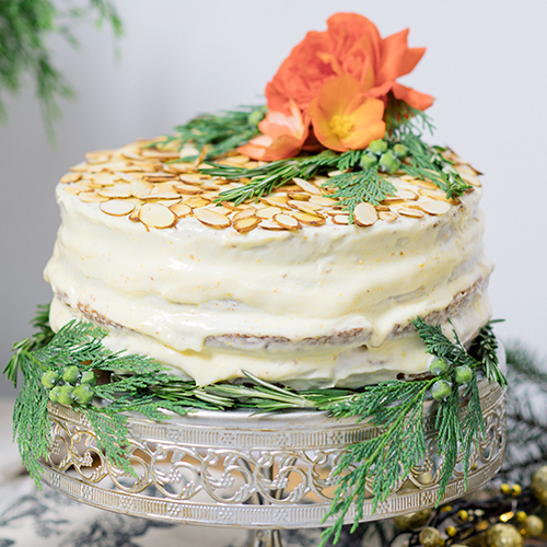 Clementine Almond Rosemary Cake topped with a decorative rose 